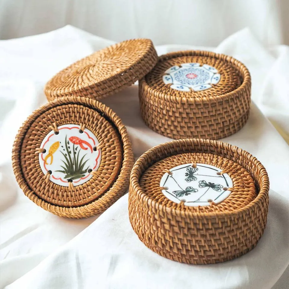 Set of handwoven rattan coasters with decorative ceramic centers in protective round holder, ideal for custom tableware manufacturing.