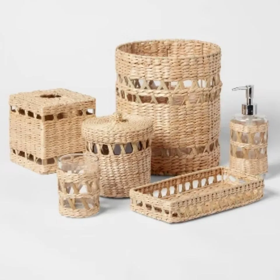 Eco-friendly water hyacinth bathroom set – open-weave handmade trash bin, tissue box, soap dispenser, tumbler, tray, and cotton jar.
