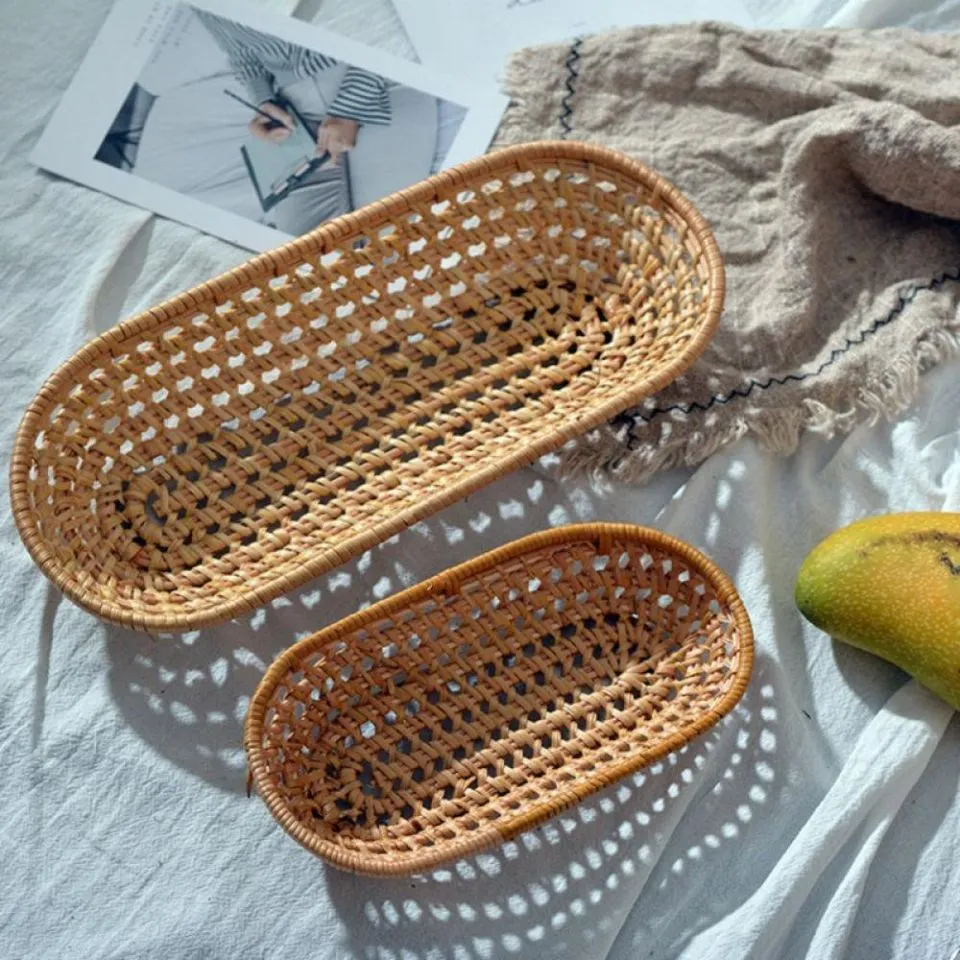 Handmade rattan bread baskets in oval shape with breathable open weave.