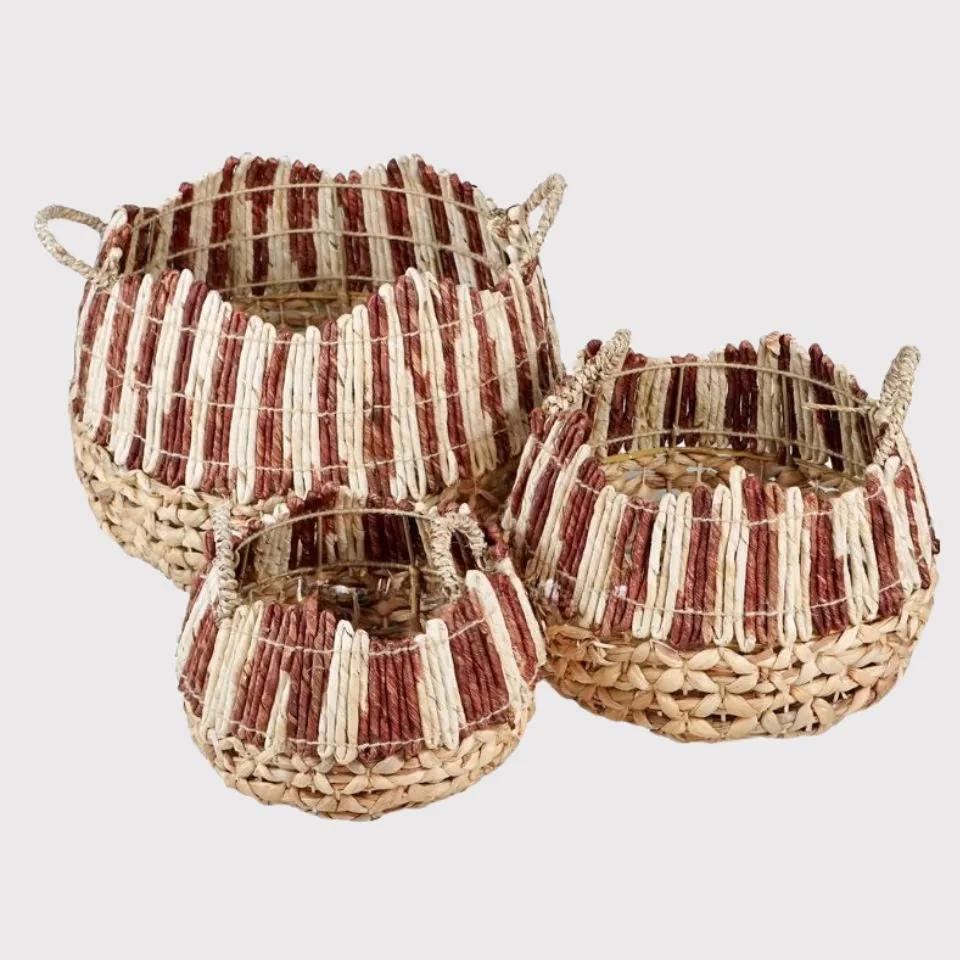 Set of 3 water hyacinth and seagrass decorative baskets with red-brown scalloped rims and handles, ethically handcrafted by EHM.