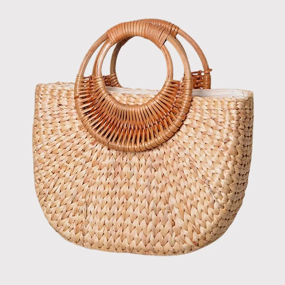 Eco-friendly water hyacinth and rattan handbag with woven round handles, produced by EHM Vietnam.