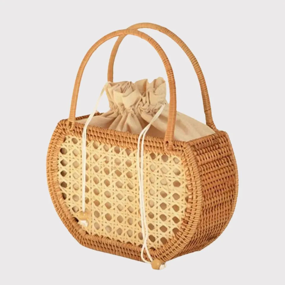 Rattan handbag with drawstring fabric lining and dual handles, ethically made by EHM.