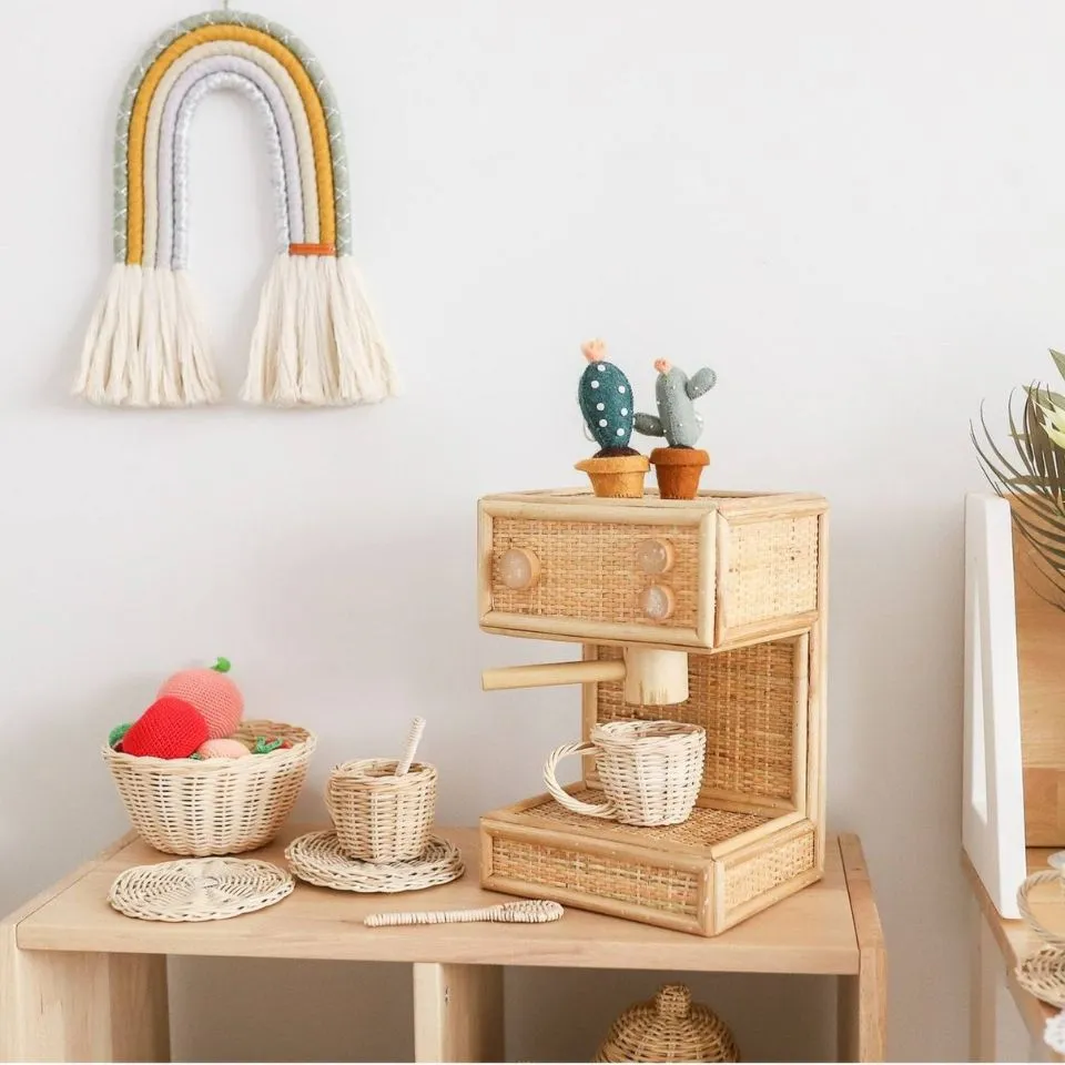 Handwoven rattan kids coffee machine playset with cups, saucers, spoon – natural Montessori toy for imaginative play.