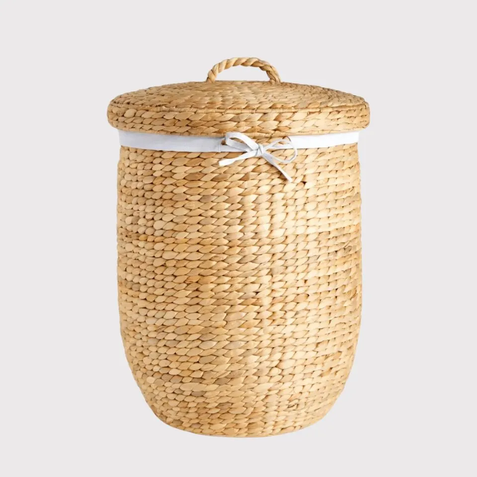 Natural water hyacinth laundry hamper with fabric liner and drawstring lid – sustainable handmade storage by EHM Vietnam.