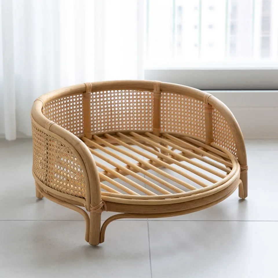 Handcrafted rattan pet bed with open-weave backrest and natural wood finish, ideal for eco-friendly pet house manufacturing.