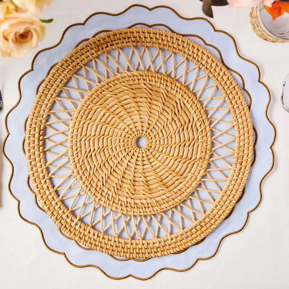 Round handwoven rattan placemat with open starburst center pattern, perfect for luxury tableware manufacturing.