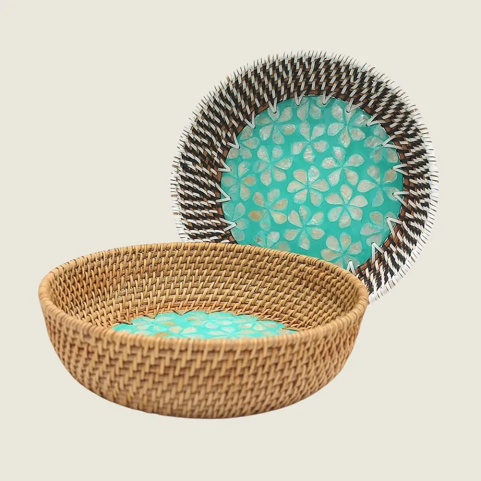 Luxury rattan bowl with iridescent mother-of-pearl floral inlay and contrasting dark weave rim