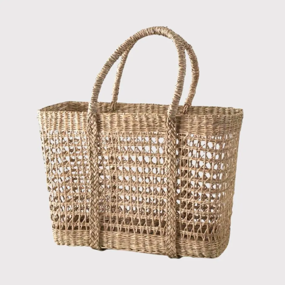 Oversized seagrass woven tote bag with open lattice design, eco-friendly beach fashion handicraft