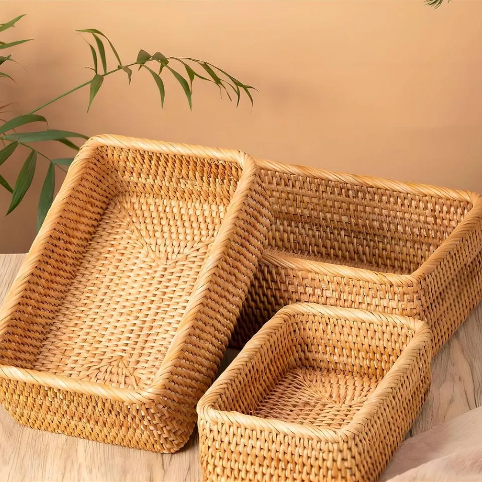 Three nested rectangular rattan storage baskets in natural finish for handmade production