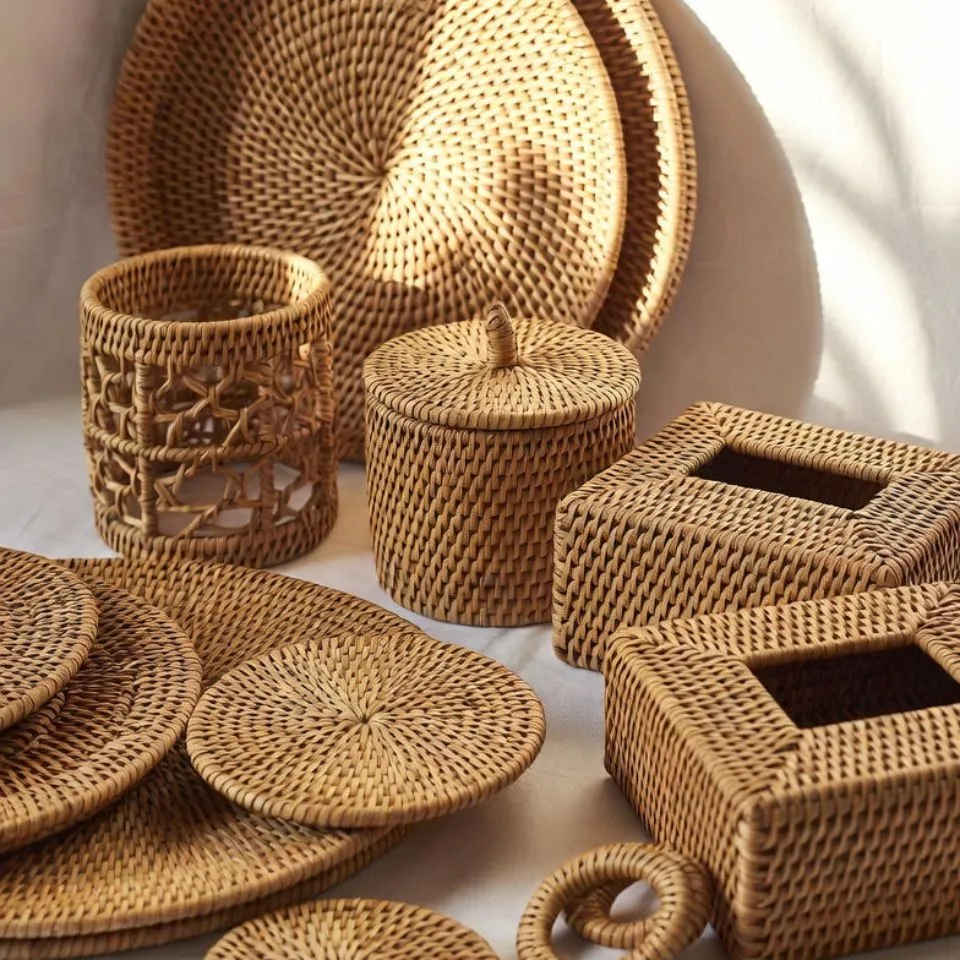 Complete handwoven rattan tableware set including charger plates, coasters, napkin rings, and tissue box covers for full OEM manufacturing solutions.