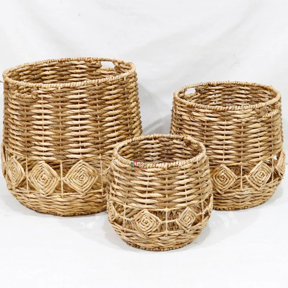 Trio of handwoven water hyacinth laundry baskets with geometric diamond patterns and sturdy handles – large, medium, small sizes.